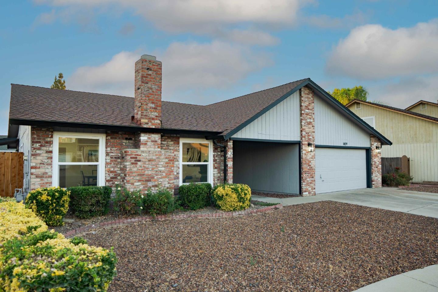 a front view of a house with garden