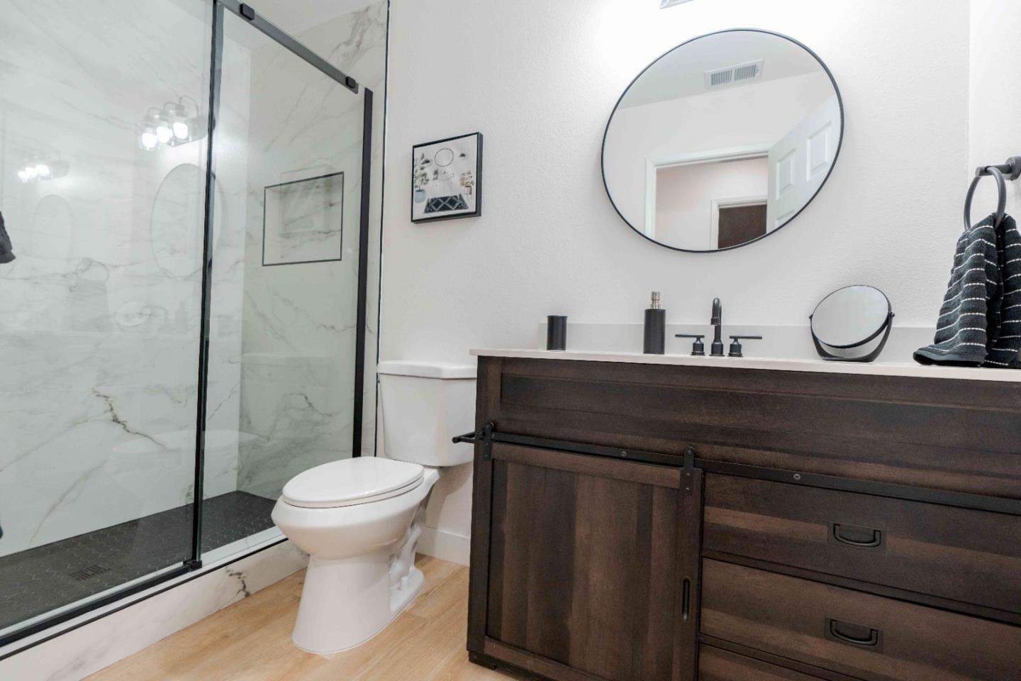1429 Chadwick Place Manteca, CA 95336 - Photo 14 of 26 a bathroom with a toilet a sink and mirror