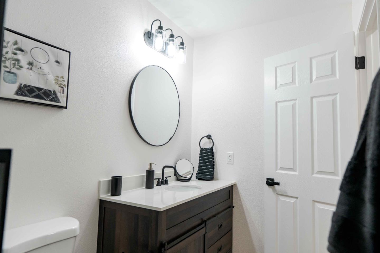1429 Chadwick Place Manteca, CA 95336 - Photo 15 of 26 a bathroom with a toilet sink and mirror