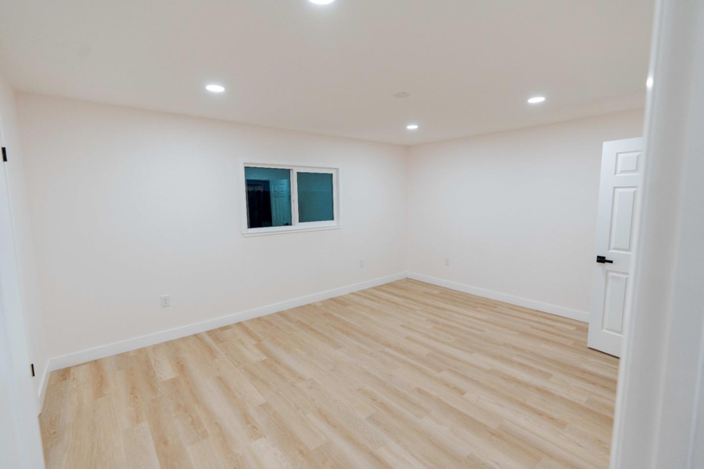 1429 Chadwick Place Manteca, CA 95336 - Photo 22 of 26 a view of an empty room with wooden floor and a window