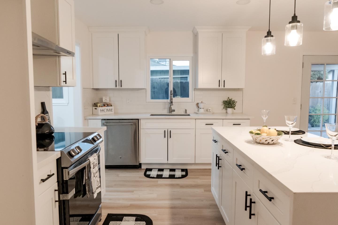 1429 Chadwick Place Manteca, CA 95336 - Photo 5 of 26 a kitchen with a sink stove and cabinets
