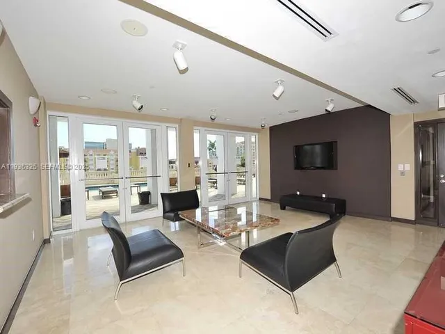 a workspace with furniture wooden floor and a flat screen tv