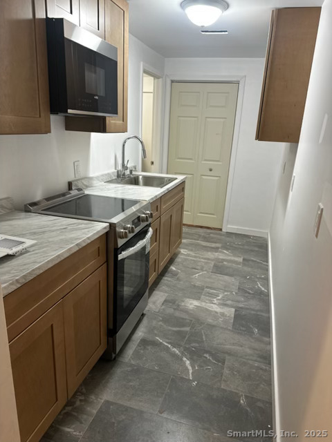 281 Spring Street Cheshire, CT 06410 - Photo 4 of 10 a kitchen with stainless steel appliances granite countertop a sink stove and microwave