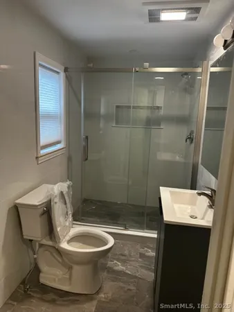a bathroom with a sink toilet and shower