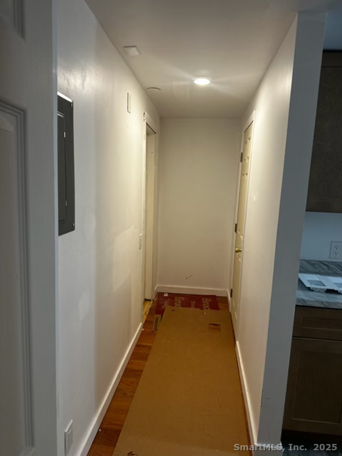 281 Spring Street Cheshire, CT 06410 - Photo 6 of 10 a view of a hallway with wooden floor and a bathroom