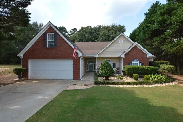 a front view of house with yard and green space