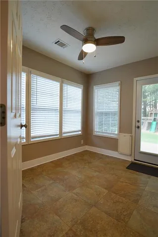 a view of a livingroom with a ceiling fan and window