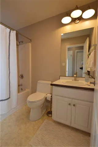 an empty room with a ceiling fan and a window