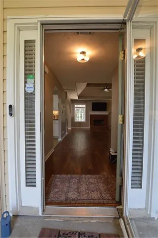 a view of living room with wooden floor and a fireplace