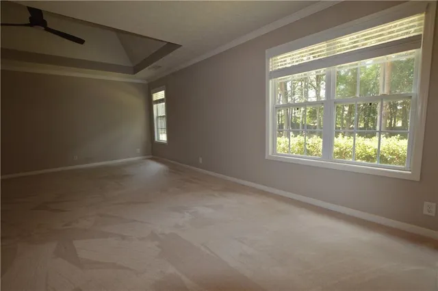 a view of a house with backyard water fountain and sitting area