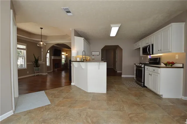 a kitchen with refrigerator and cabinets