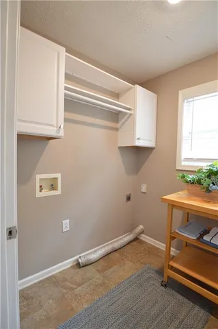a room with a wooden floor and cabinets