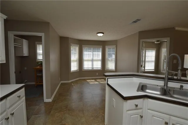a view of a bathroom sink mirror and window