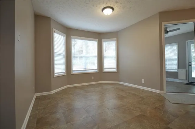 an empty room with windows and closet