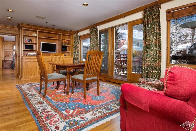 304 Bridge Street, Unit 3 Vail, CO 81657 - Photo 7 of 11 a living room with furniture a flat screen tv and floor to ceiling window