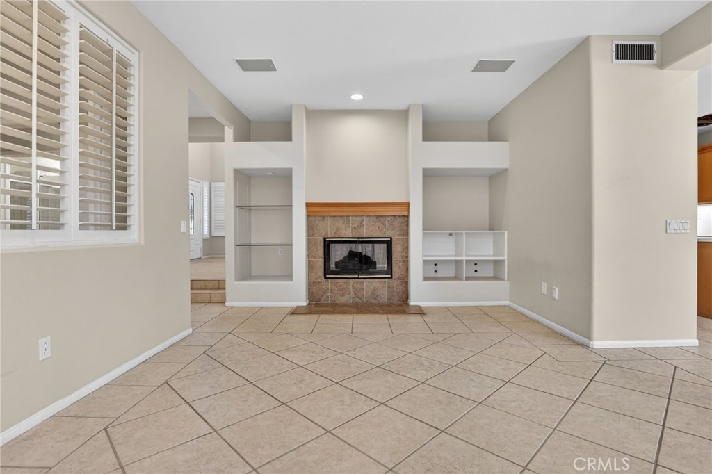 20543 Pesaro Porter Ranch Porter Ranch, CA 91326 - Photo 15 of 67 a view of an empty room with a fireplace and a window