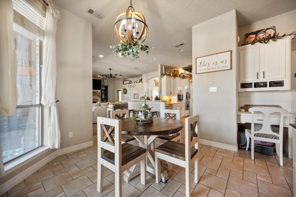 212 Ashmore Place Haslet, TX 76052 - Photo 12 of 39 Dining room with recessed lighting, a chandelier, and light stone finish flooring