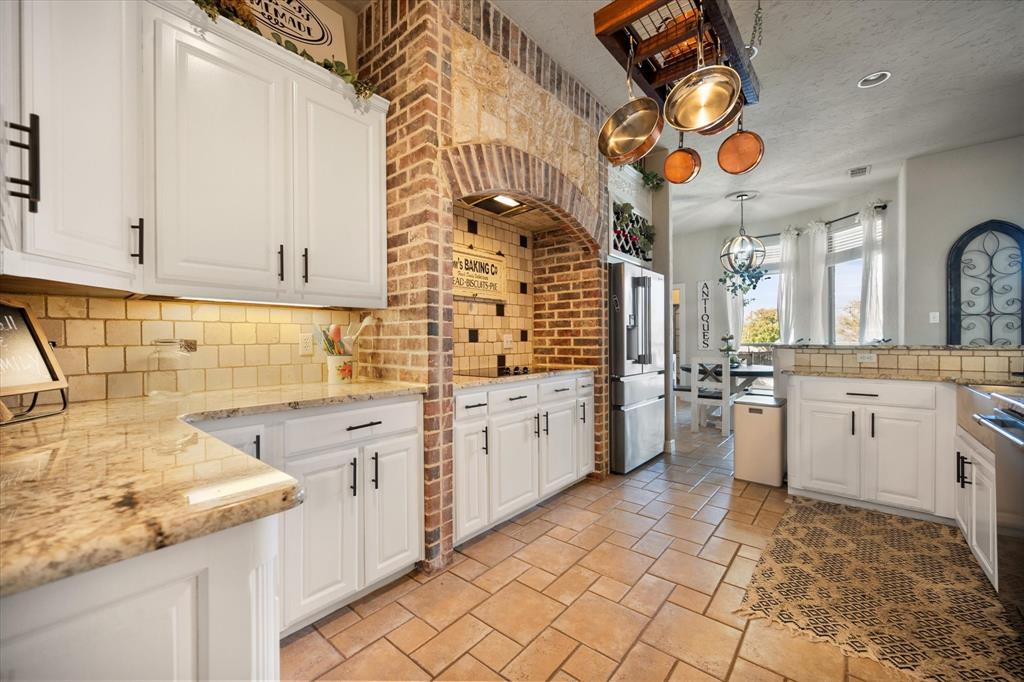 212 Ashmore Place Haslet, TX 76052 - Photo 15 of 39 Kitchen with white cabinets, tasteful backsplash, appliances with stainless steel finishes, a textured ceiling, and recessed lighting