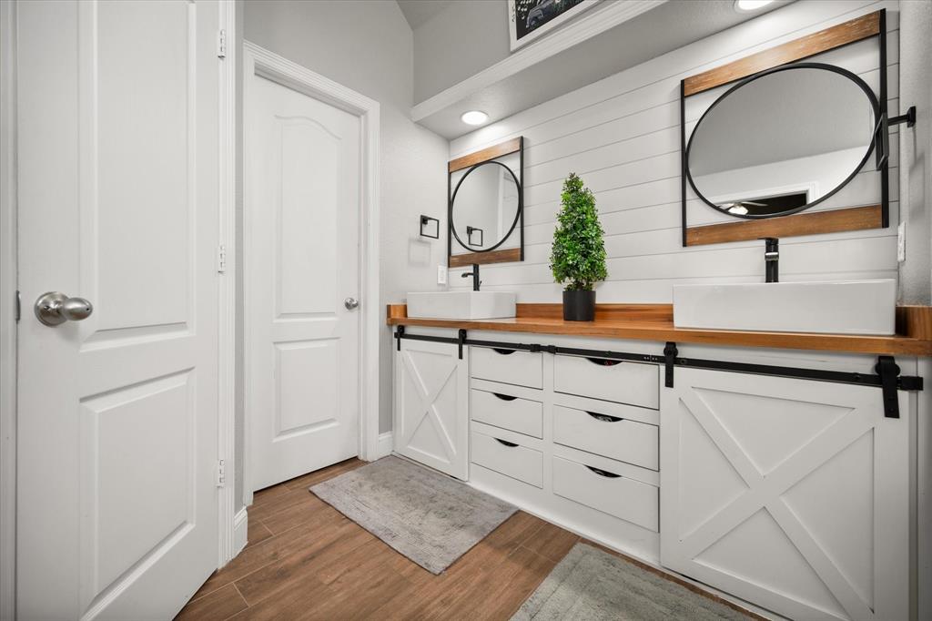 212 Ashmore Place Haslet, TX 76052 - Photo 21 of 39 Bathroom with dark wood-style flooring and double vanity