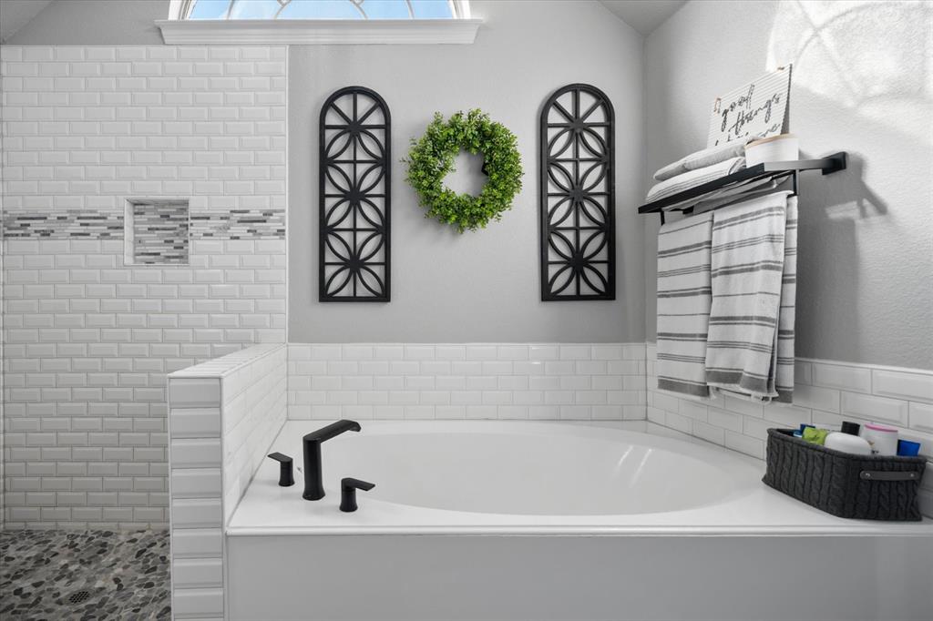 212 Ashmore Place Haslet, TX 76052 - Photo 22 of 39 Full bathroom featuring a bath and tiled shower