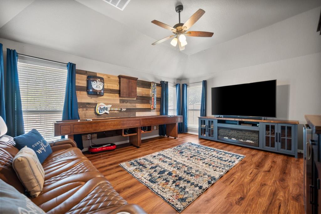 212 Ashmore Place Haslet, TX 76052 - Photo 30 of 39 Living room featuring lofted ceiling, wood finished floors, and a ceiling fan