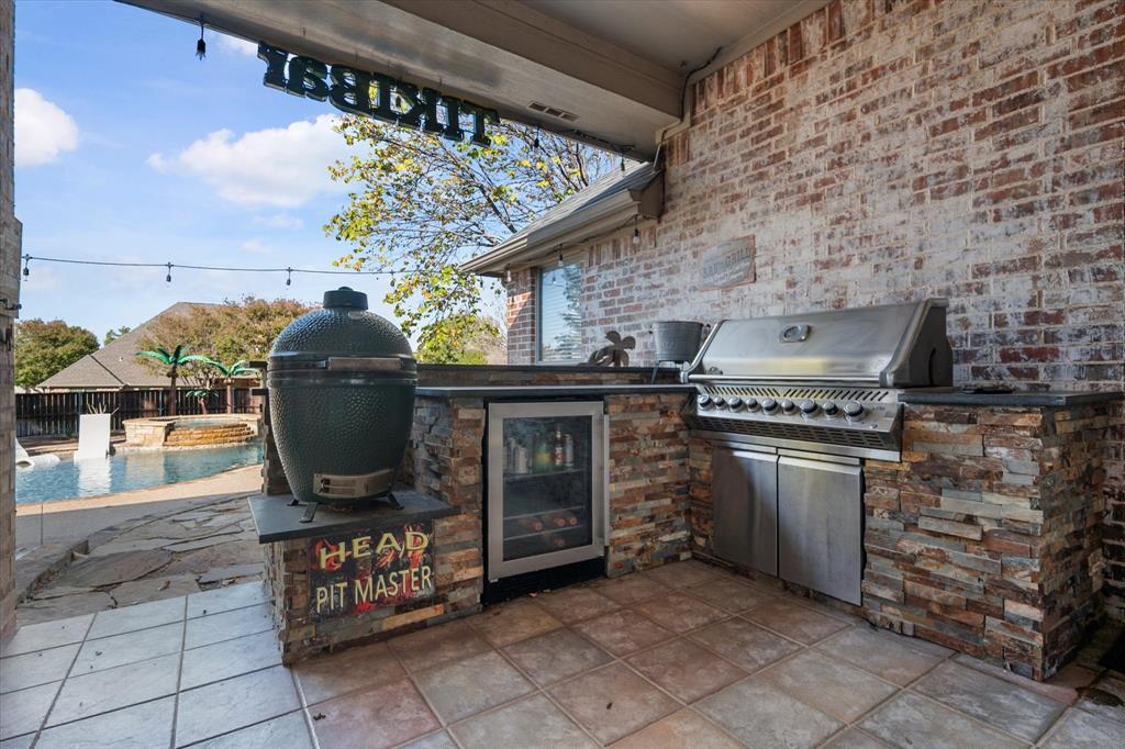 212 Ashmore Place Haslet, TX 76052 - Photo 34 of 39 View of patio with area for grilling and a pool with connected hot tub