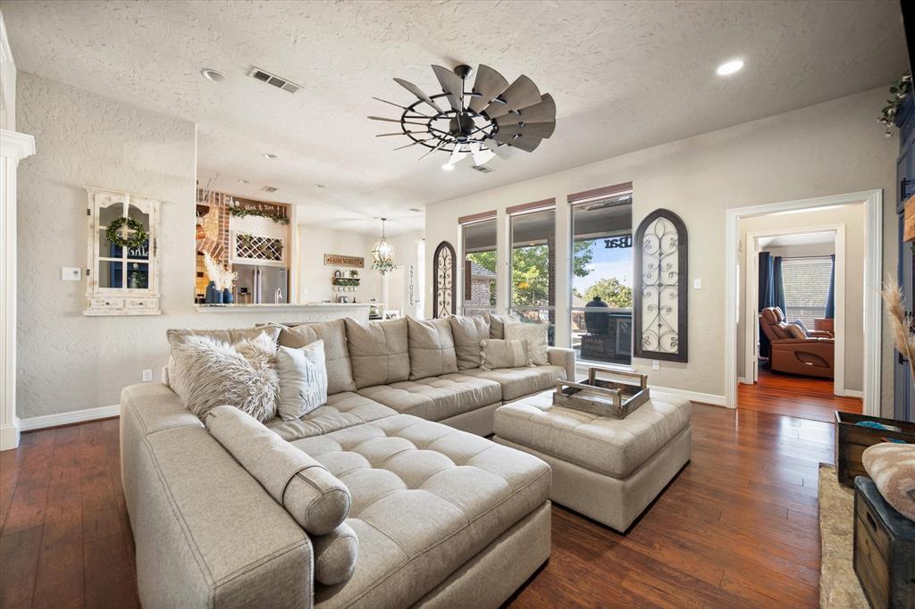 212 Ashmore Place Haslet, TX 76052 - Photo 8 of 39 Living room with dark wood finished floors, a chandelier, a textured ceiling, recessed lighting, and ceiling fan