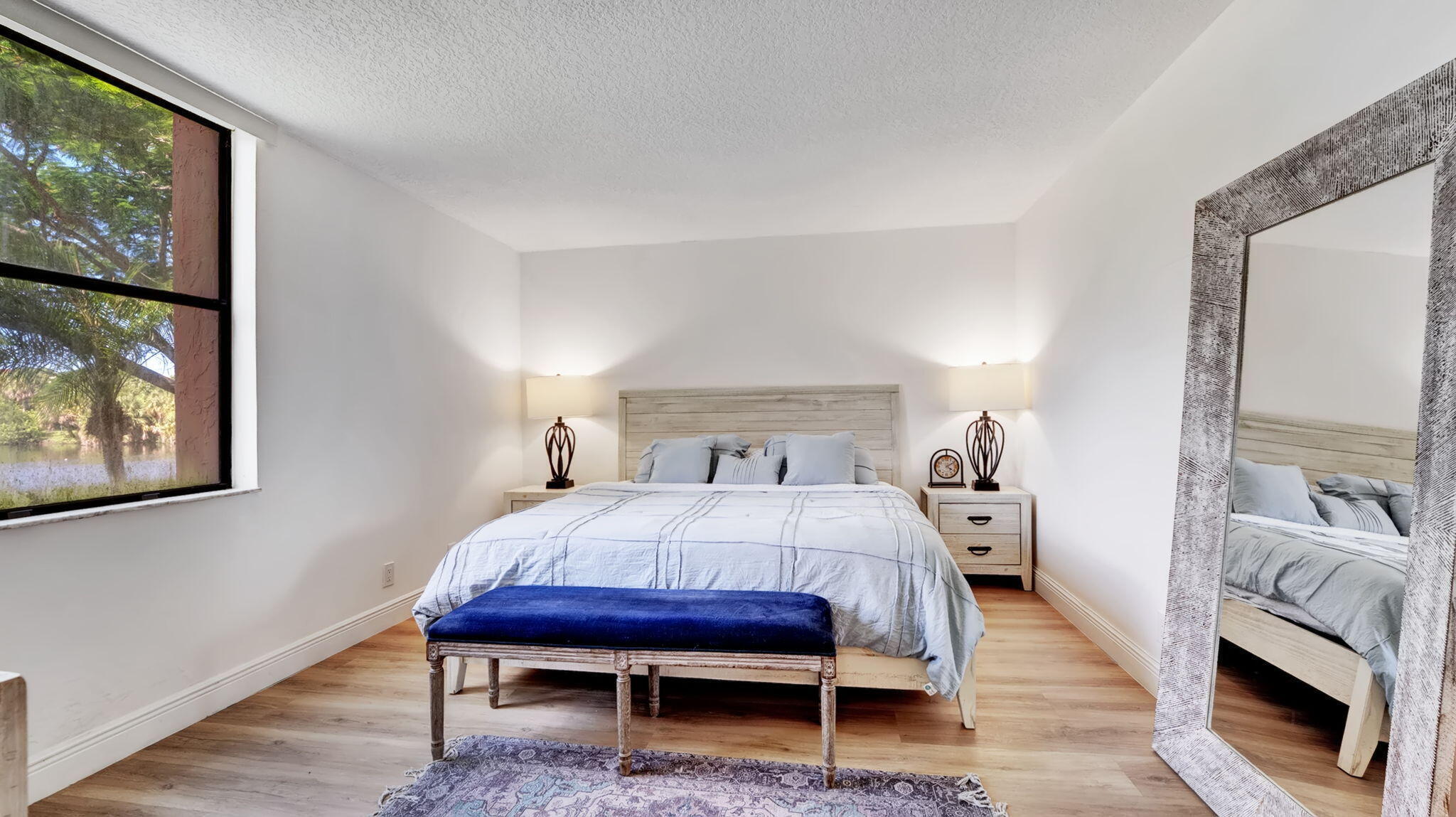 955 Dotterel Road, Unit 2103 Delray Beach, FL 33444 - Photo 8 of 23 a bedroom with a bed table and a flat screen tv