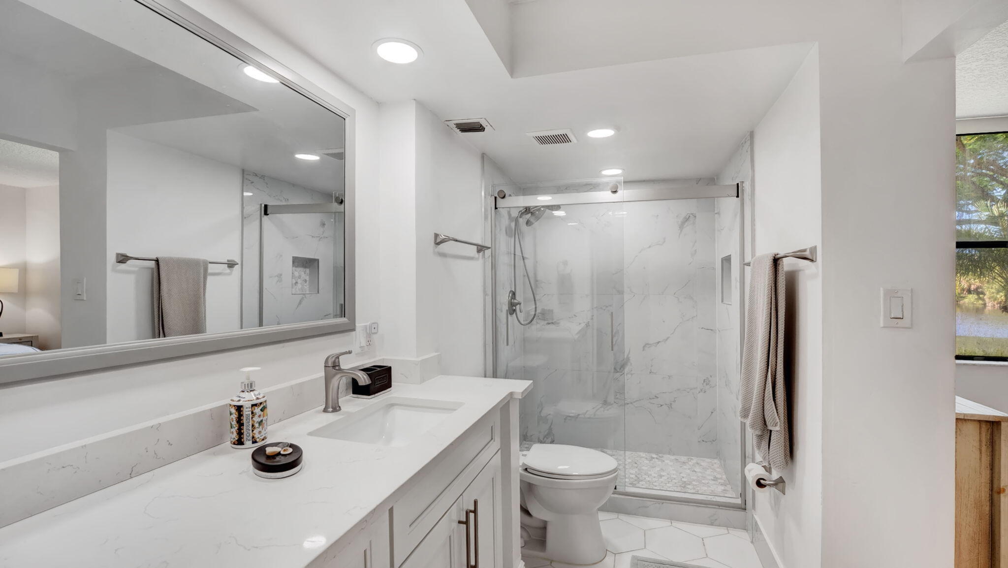 955 Dotterel Road, Unit 2103 Delray Beach, FL 33444 - Photo 9 of 23 a bathroom with a sink a toilet a mirror and shower