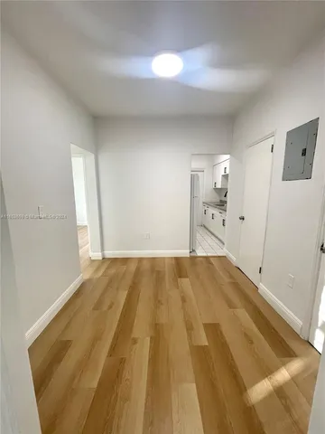 a spacious bedroom with a bed and a cabinets