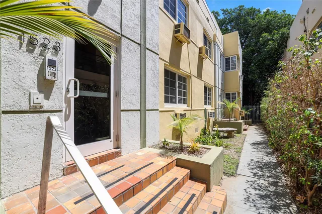 a view of a patio with a table and chairs