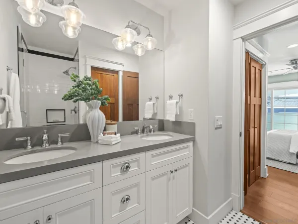 a bathroom with a sink double vanity and a mirror