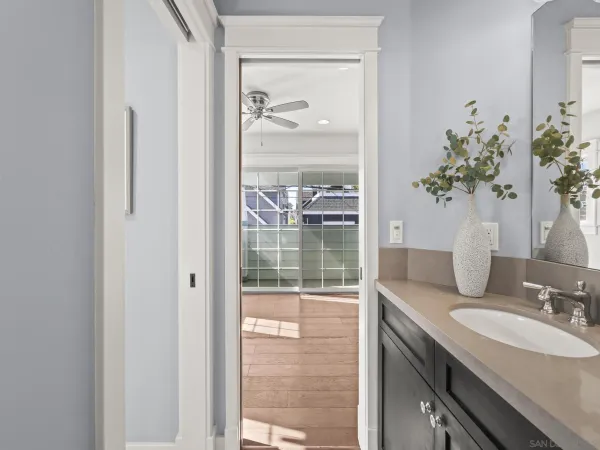 a bathroom with a granite countertop sink a mirror and a shower