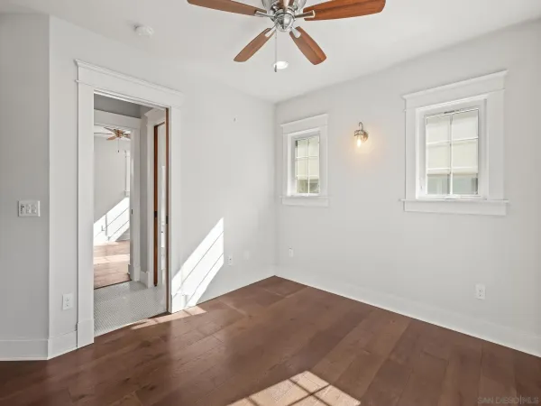 a view of a livingroom with a ceiling fan and window