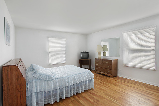 300 Lee Road Northbrook, IL 60062 - Photo 14 of 19 a bedroom with a bed and wooden floor