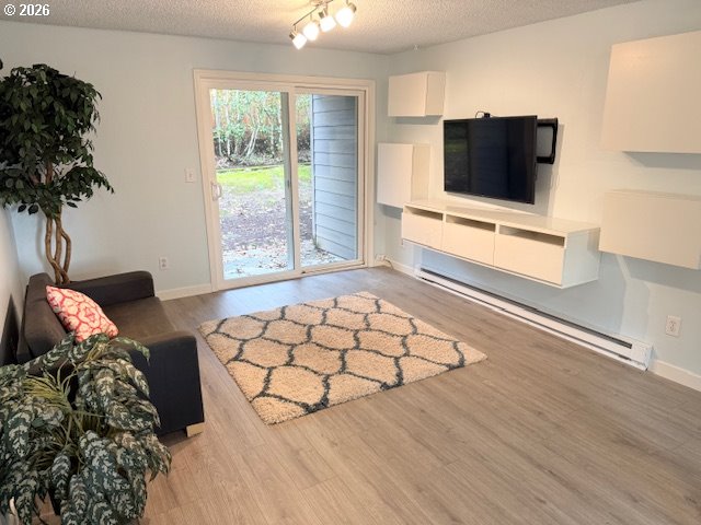 12628 Northwest Barnes Road, Unit 6 Portland, OR 97229 - Photo 4 of 13 a living room with furniture and a flat screen tv