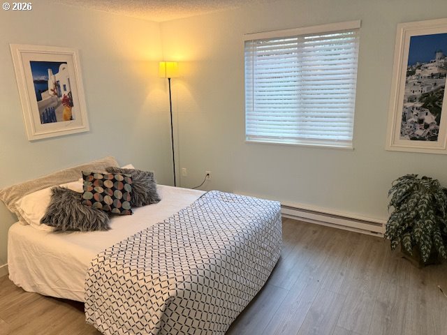 12628 Northwest Barnes Road, Unit 6 Portland, OR 97229 - Photo 8 of 13 a bedroom with a bed and a window