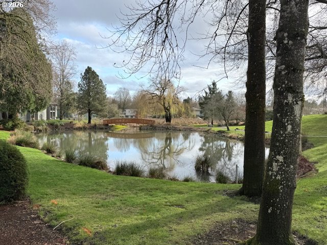 12628 Northwest Barnes Road, Unit 6 Portland, OR 97229 - Photo 10 of 13 a view of a lake with a yard and large trees