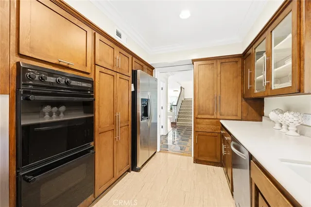 a kitchen with a sink cabinets and wooden floor