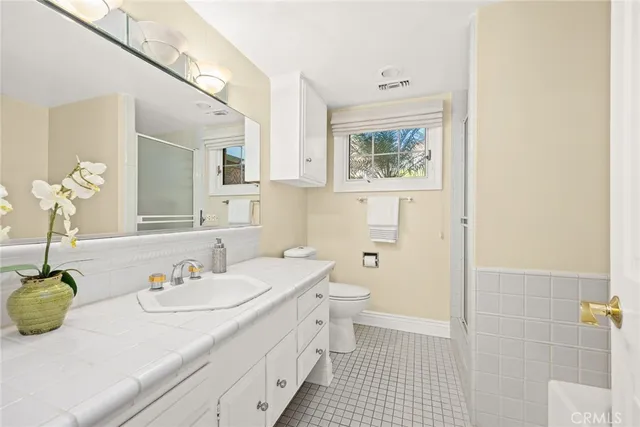 a bedroom with a large bed and a large window