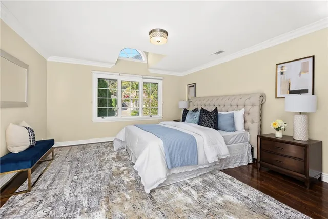 a bedroom with furniture and a wooden floor