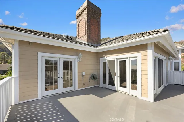 a bedroom with a bed and a large window with the outer view