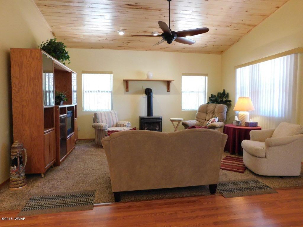 2968 Monica Road Overgaard, AZ 85933 - Photo 14 of 29 a living room with furniture and a flat screen tv