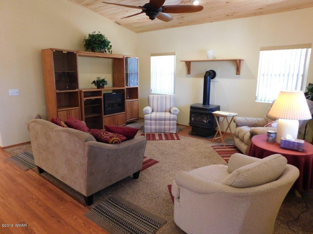 2968 Monica Road Overgaard, AZ 85933 - Photo 15 of 29 a living room with furniture and a flat screen tv
