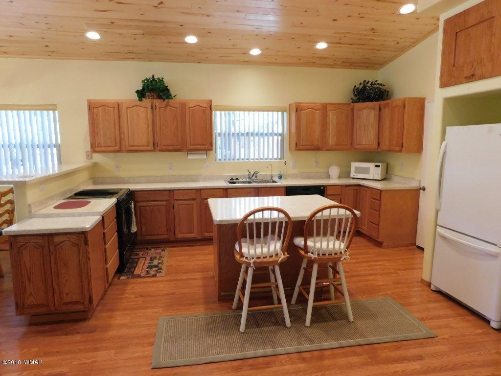 2968 Monica Road Overgaard, AZ 85933 - Photo 17 of 29 a kitchen with a table chairs sink and microwave
