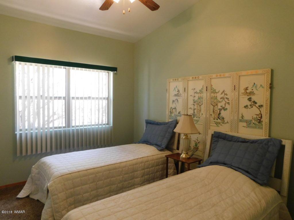 2968 Monica Road Overgaard, AZ 85933 - Photo 22 of 29 a bedroom with two beds and a window