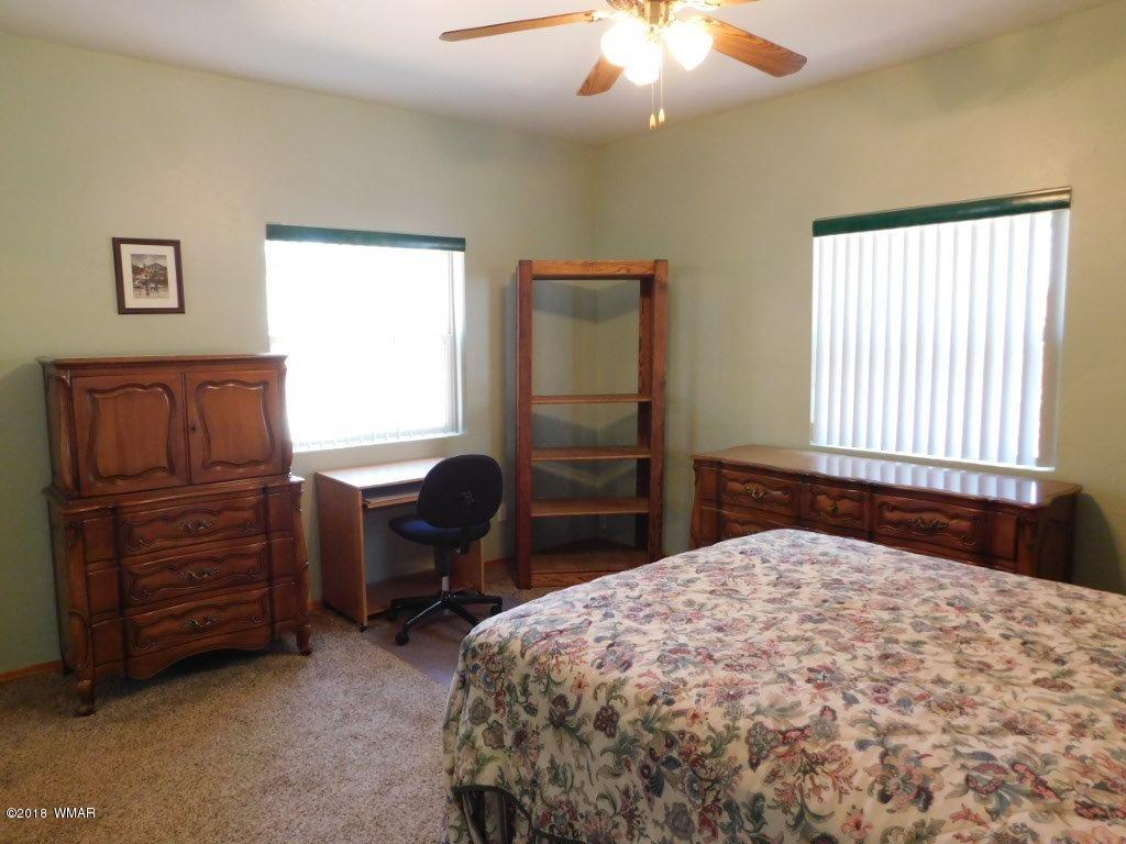 2968 Monica Road Overgaard, AZ 85933 - Photo 23 of 29 a bedroom with a bed and furniture