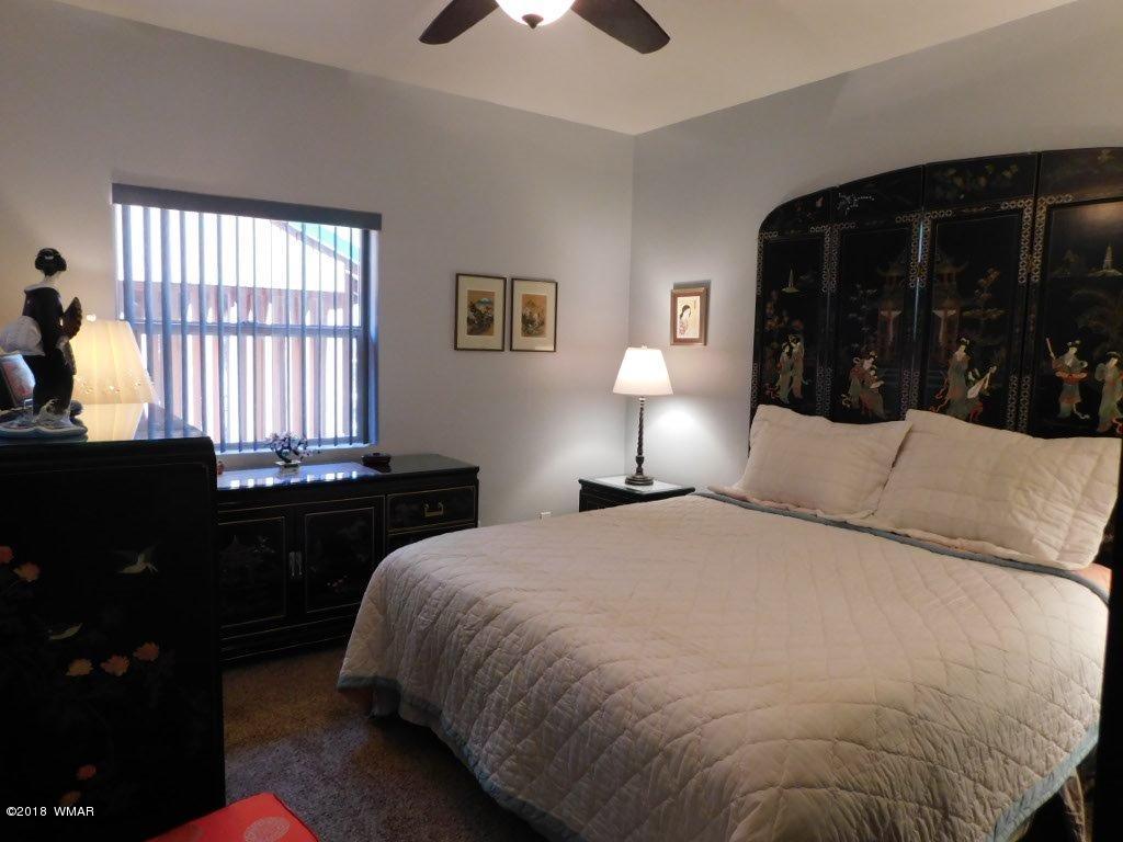 2968 Monica Road Overgaard, AZ 85933 - Photo 25 of 29 a bed room with a bed and a night stand
