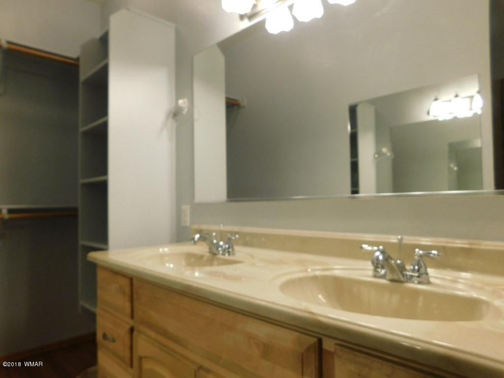 2968 Monica Road Overgaard, AZ 85933 - Photo 29 of 29 a bathroom with a sink and a mirror