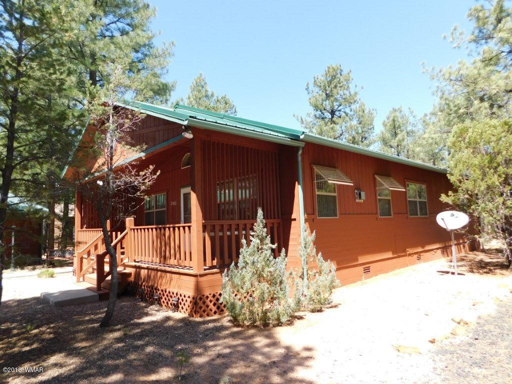 2968 Monica Road Overgaard, AZ 85933 - Photo 7 of 29 a front view of a house with a yard